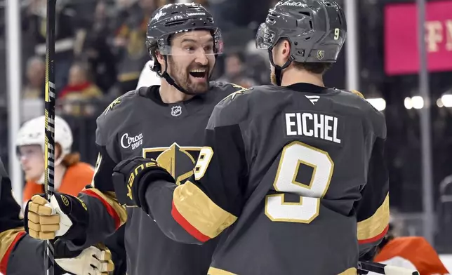 Vegas Golden Knights right wing Mark Stone, left, celebrates with center Jack Eichel (9) after scoring against the Philadelphia Flyers during the second period of an NHL hockey game Thursday, Jan. 2, 2025, in Las Vegas. (AP Photo/David Becker)