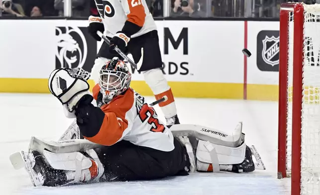 Philadelphia Flyers goaltender Aleksei Kolosov (35) watch the puck pass by him during the second period of an NHL hockey game against the Vegas Golden Knights Thursday, Jan. 2, 2025, in Las Vegas. (AP Photo/David Becker)