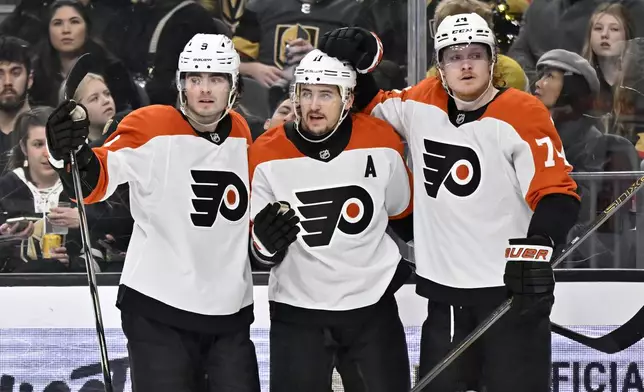 The Philadelphia Flyers celebrate right wing Travis Konecny's, center, goal against the Vegas Golden Knights during the third period of an NHL hockey game, Thursday, Jan. 2, 2025, in Las Vegas. (AP Photo/David Becker)