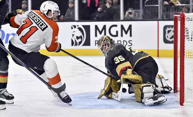 Vegas Golden Knights goaltender Ilya Samsonov (35) stops a shot by Philadelphia Flyers right wing Tyson Foerster (71) during the third period of an NHL hockey game, Thursday, Jan. 2, 2025, in Las Vegas. (AP Photo/David Becker)