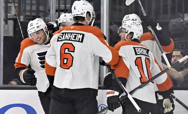 The Philadelphia Flyers celebrate right wing Tyson Foerster's, left, goal against the Vegas Golden Knights during the first period of an NHL hockey game Thursday, Jan. 2, 2025, in Las Vegas. (AP Photo/David Becker)