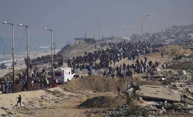 Displaced Palestinians walk on a road in central Gaza to return to their homes in the northern Gaza Strip, Wednesday, Jan. 29, 2025. (AP Photo/Abdel Kareem Hana)