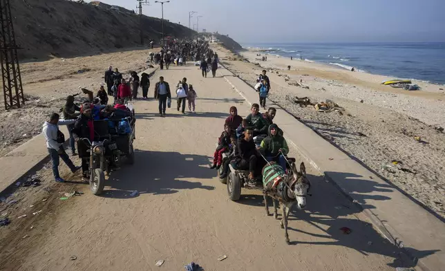 Displaced Palestinians walk on a road in central Gaza to return to their homes in the northern Gaza Strip, Wednesday, Jan. 29, 2025. (AP Photo/Abdel Kareem Hana)