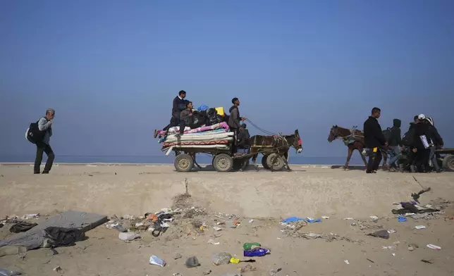 Displaced Palestinians walk on a road in central Gaza to return to their homes in the northern Gaza Strip, Wednesday, Jan. 29, 2025. (AP Photo/Abdel Kareem Hana)