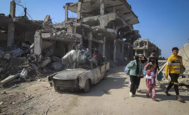 Displaced Palestinians arrive to Beit Lahia, northern Gaza Strip, Wednesday, Jan. 29, 2025, after Israel began allowing hundreds of thousands of Palestinians to return to the heavily damaged area last Monday. (AP Photo/Jehad Alshrafi)