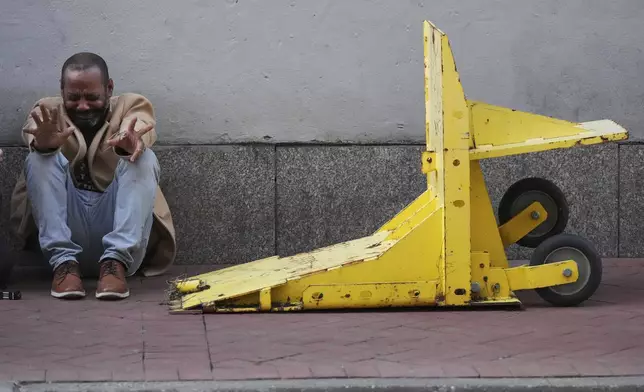 Jovon Bell from New York, who said he was injured in the New Year's attack, reacts near a temporary barriers set up in the French Quarter, Thursday, Jan. 2, 2025, in New Orleans. (AP Photo/George Walker IV)