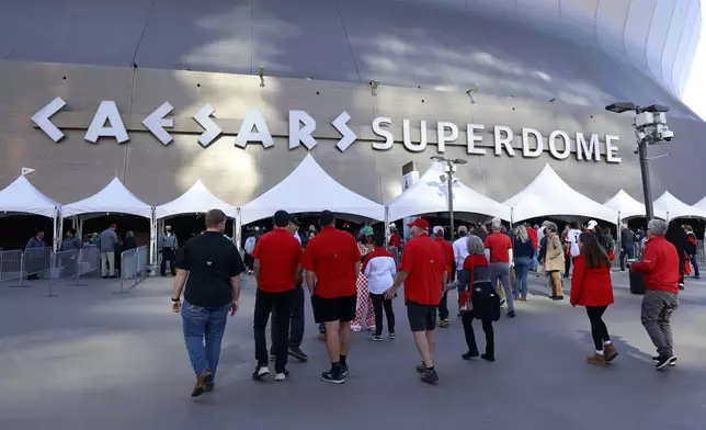 Fans walk through security checkpoints as they enter Caesars Superdome ahead of the Sugar Bowl NCAA College Football Playoff game, Thursday, Jan. 2, 2025, in New Orleans. (AP Photo/Butch Dill)