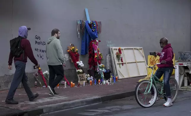 People view a memorial to the victims of a deadly truck attack on Bourbon Street in the French Quarter, Friday, Jan. 3, 2025, in New Orleans. (AP Photo/George Walker IV)