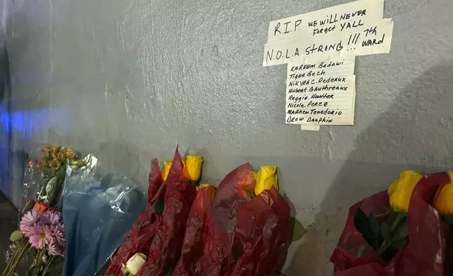 A makeshift memorial on the corner of Bourbon street, Thursday, Jan. 2, 2025, lists the names of some of the victims of the deadly attack, in New Orleans. (AP Photo/Jack Brook)