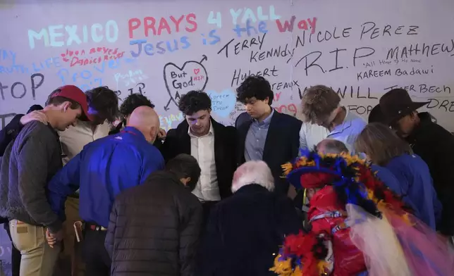 Friends of Kareem Badawi, a victim of the deadly truck attack on New Year's Day in New Orleans, pray at a memorial for victims after attending his funeral, Friday, Jan. 3, 2025. (AP Photo/Gerald Herbert)