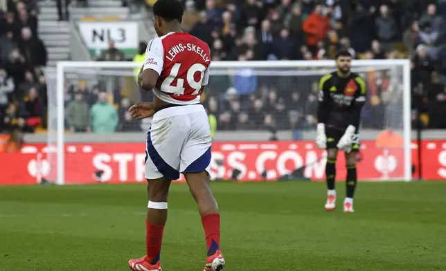 Arsenal's Myles Lewis-Skelli leaves the pitch after being sent off during the English Premier League soccer match between Wolverhampton Wanderers and Arsenal at the Molineux Stadium in Wolverhampton, England, Saturday, Jan. 25, 2025. (AP Photo/Rui Vieira)