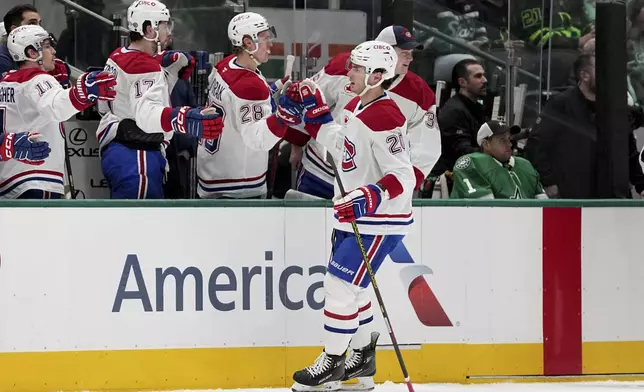 Montreal Canadiens left wing Juraj Slafkovsky (20) celebrates with the bench after scoring against the Dallas Stars in the first period of an NHL hockey game in Dallas, Thursday, Jan. 16, 2025. (AP Photo/Tony Gutierrez)