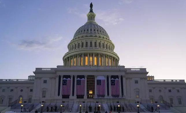The sun rises as a rehearsal begins for President-elect Donald Trump's upcoming inauguration on the West Front of the U.S. Capitol, Sunday, Jan. 12, 2025, in Washington. (AP Photo/Jon Elswick)
