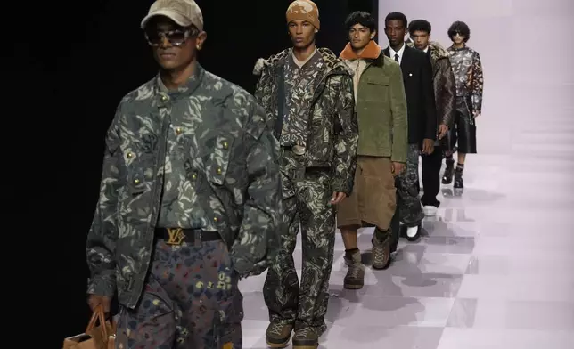 Models wear creations as part of the men's Louis Vuitton Fall-Winter 2025-2026 collection, that was presented in Paris, Tuesday, Jan. 21, 2025. (AP Photo/Michel Euler)