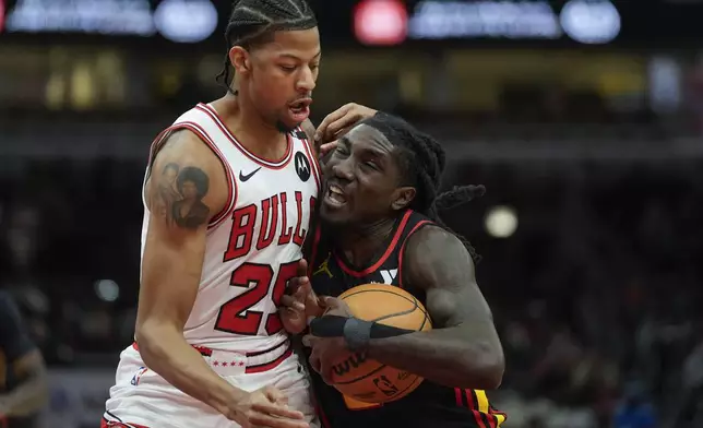 Chicago Bulls forward Dalen Terry (25), left, fouls Atlanta Hawks guard Keaton Wallace (2) during the first half of an NBA basketball game Wednesday, Jan. 15, 2025, in Chicago. (AP Photo/Erin Hooley)