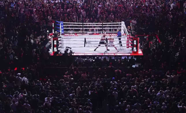 FILE - Mike Tyson, left, fights Jake Paul during their heavyweight boxing match, Nov. 15, 2024, in Arlington, Texas. (AP Photo/Julio Cortez, File)