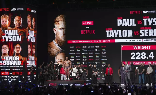 FILE - Mike Tyson steps on the scale during a weigh-in ahead of his heavyweight bout against Jake Paul, in Irving, Texas, in Irving, Texas. (AP Photo/Julio Cortez, File)