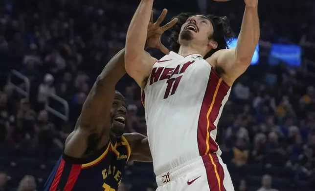 Miami Heat forward Jaime Jaquez Jr., right, is fouled by Golden State Warriors forward Draymond Green during the first half of an NBA basketball game Tuesday, Jan. 7, 2025, in San Francisco. (AP Photo/Godofredo A. Vásquez)