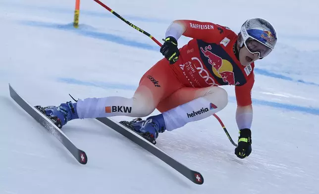 Switzerland's Marco Odermatt speeds down the course during an alpine ski, men's World Cup downhill, in Kitzbühel, Austria, Saturday, Jan. 25, 2025. (AP Photo/Marco Trovati)