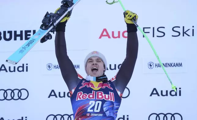The winner Canada's James Crawford celebrates after an alpine ski, men's World Cup downhill in Kitzbühel, Austria, Saturday, Jan. 25, 2025. (AP Photo/Giovanni Auletta)