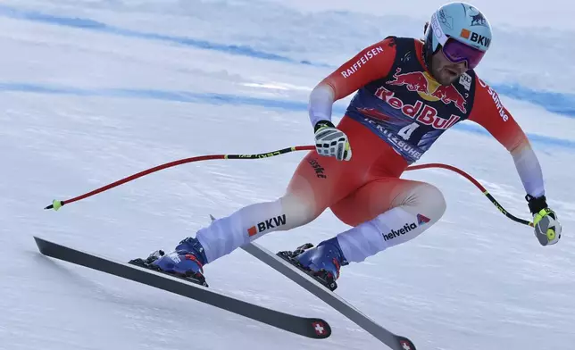 Switzerland's Alexis Monney speeds down the course during an alpine ski, men's World Cup downhill, in Kitzbühel, Austria, Saturday, Jan. 25, 2025. (AP Photo/Marco Trovati)