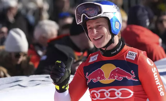 Switzerland's Marco Odermatt reacts after completing an alpine ski, men's World Cup downhill in Kitzbühel, Austria, Saturday, Jan. 25, 2025. (AP Photo/Giovanni Auletta)