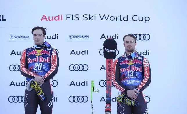 The winner Canada's James Crawford and third placed Canada's Cameron Alexander listen from their national anthem after an alpine ski, men's World Cup downhill in Kitzbühel, Austria, Saturday, Jan. 25, 2025. (AP Photo/Giovanni Auletta)