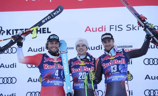 From left, second placed Switzerland's Alexis Monney, the winner Canada's James Crawford and third placed Canada's Cameron Alexander celebrate after an alpine ski, men's World Cup downhill in Kitzbühel, Austria, Saturday, Jan. 25, 2025. (AP Photo/Giovanni Auletta)