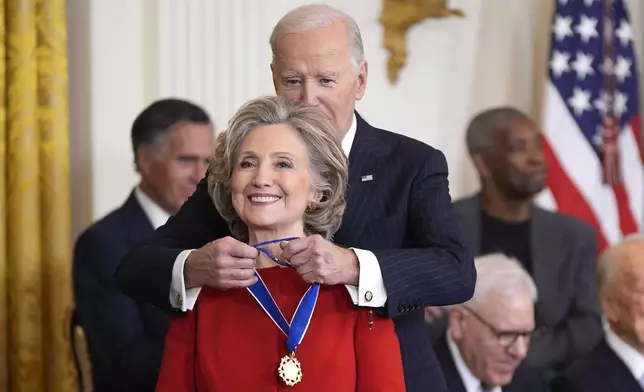 President Joe Biden, right, presents the Presidential Medal of Freedom, the Nation's highest civilian honor, to former Secretary of State Hillary Clinton, in the East Room of the White House, Saturday, Jan. 4, 2025, in Washington. (AP Photo/Manuel Balce Ceneta)