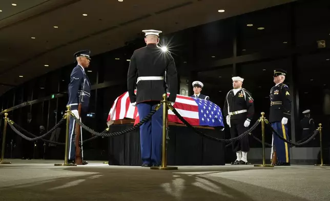 The Guard of Honor surrounds the flag-draped casket of former President Jimmy Carter as he lies in repose at the Jimmy Carter Presidential Library and Museum in Atlanta, Saturday, Jan. 4, 2025. Carter died Dec. 29 at the age of 100. (AP Photo/Alex Brandon, Pool)