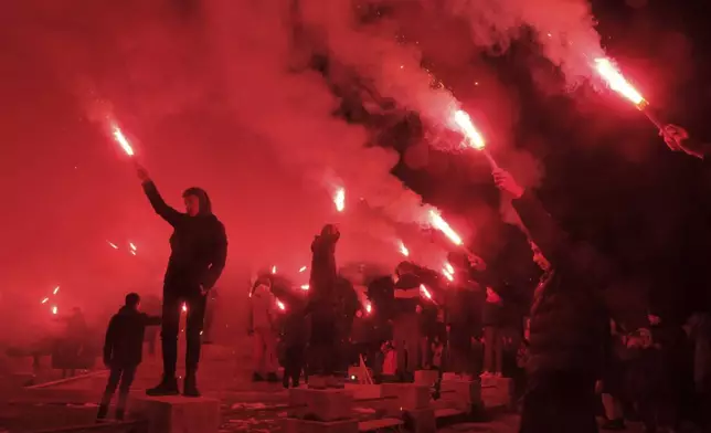 Children light torches during a protest demanding the resignations of top security officials over a shooting earlier this week in Cetinje, outside of Podogrica, Montenegro, Sunday, Jan 5, 2025. (AP Photo/Risto Bozovic)