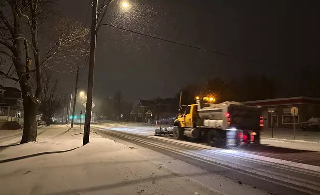 A snowplow passes through Lowville, New York, on Saturday, Jan. 4, 2025. (AP Photo/Cara Anna)