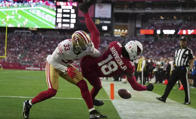 San Francisco 49ers cornerback Rock Ya-Sin (33) knocks the ball away from Arizona Cardinals wide receiver Marvin Harrison Jr. (18) during the second half of an NFL football game in Glendale, Ariz., Sunday, Jan. 5, 2025. (AP Photo/Rick Scuteri)