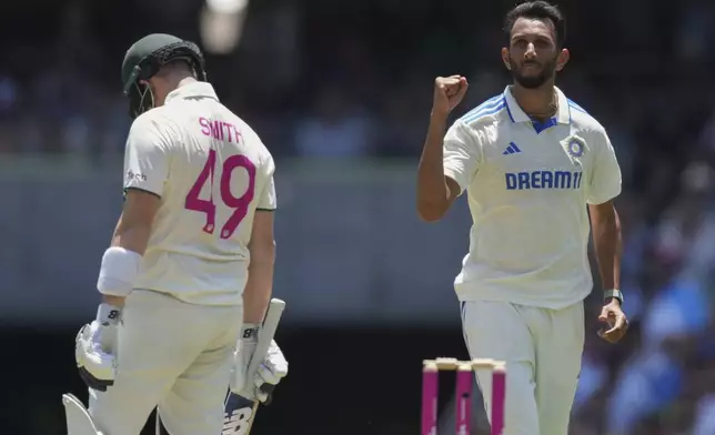 India's Prasidh Krishna, right, reacts after dismissing Australia's Steve Smith during play on the second day of the fifth cricket test between India and Australia at the Sydney Cricket Ground, in Sydney, Australia, Saturday, Jan. 4, 2025. (AP Photo/Mark Baker)