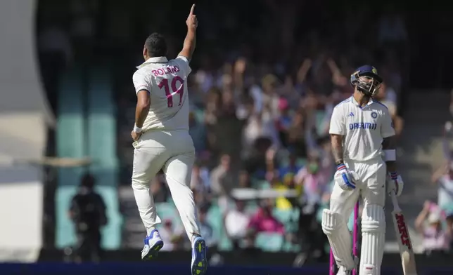 Australia's Scott Boland, left, celebrates after dismissing India's Virat Kohli, right, during play on the second day of the fifth cricket test between India and Australia at the Sydney Cricket Ground, in Sydney, Australia, Saturday, Jan. 4, 2025. (AP Photo/Mark Baker)