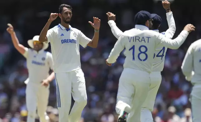 India's Prasidh Krishna is congratulated by teammates after dismissing Australia's Steve Smith during play on the second day of the fifth cricket test between India and Australia at the Sydney Cricket Ground, in Sydney, Australia, Saturday, Jan. 4, 2025. (AP Photo/Mark Baker)