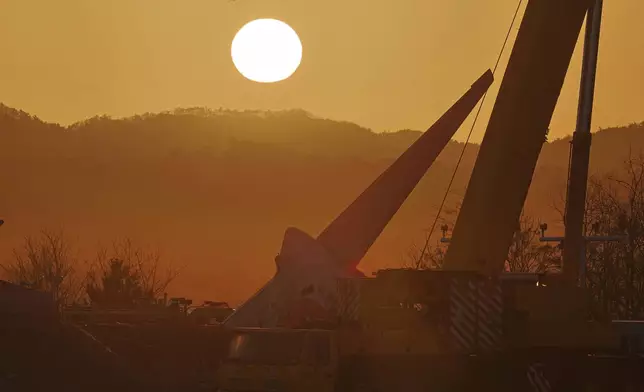 The first sunrise on New Year's day is seen near the site of a plane crash at Muan International Airport in Muan, South Korea, Wednesday, Jan. 1, 2025. (Son Hyung-ju/Yonhap via AP)