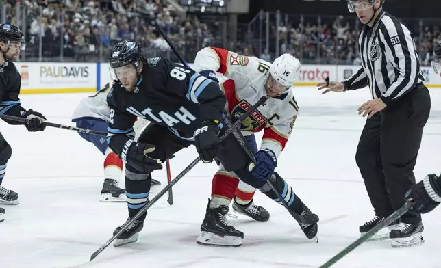 Utah Hockey Club center Kevin Stenlund (82) fights for the puck against Florida Panthers center Aleksander Barkov (16) during the second period of an NHL hockey game, Wednesday, Jan. 8, 2025, in Salt Lake City. (AP Photo/Melissa Majchrzak)