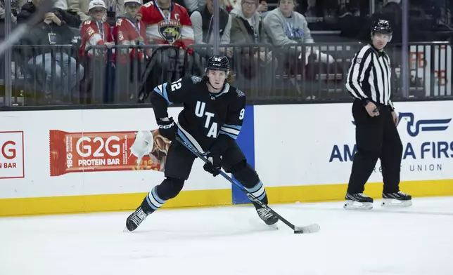 Utah Hockey Club center Logan Cooley (92) looks to pass the puck against the Florida Panthers during the first period of an NHL hockey game, Wednesday, Jan. 8, 2025, in Salt Lake City. (AP Photo/Melissa Majchrzak)