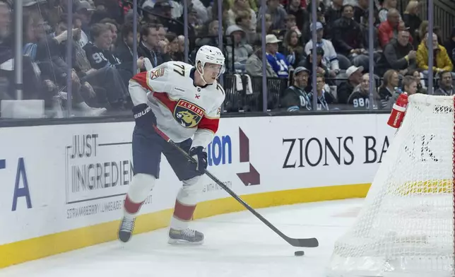 Florida Panthers defenseman Niko Mikkola (77) moves the puck against the Utah Hockey Club during the first period of an NHL hockey game, Wednesday, Jan. 8, 2025, in Salt Lake City. (AP Photo/Melissa Majchrzak)