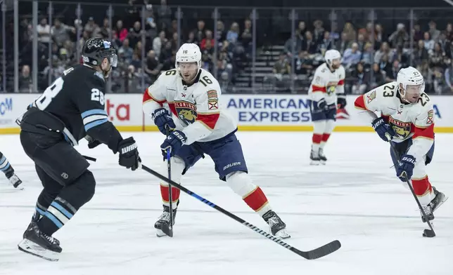 Florida Panthers center Aleksander Barkov (16) defends as center Carter Verhaeghe (23) can bring the puck up the ice against Utah Hockey Club defenseman Ian Cole (28) during the second period of an NHL hockey game, Wednesday, Jan. 8, 2025, in Salt Lake City. (AP Photo/Melissa Majchrzak)