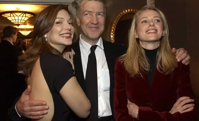 FILE - Director David Lynch, center, poses with actors Laura Elena Harring, left, and Naomi Watts, from his film "Mulholland Drive," at the Los Angeles Film Critics 27th Annual Achievement Awards in Santa Monica, Calif., on Jan. 22, 2002. (AP Photo/Lucy Nicholson, File)
