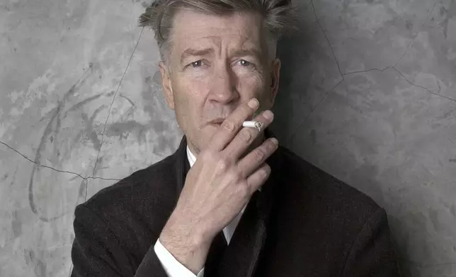 FILE - Filmmaker David Lynch poses at his Los Angeles home March 14, 2002. (AP Photo/Chris Weeks, File)