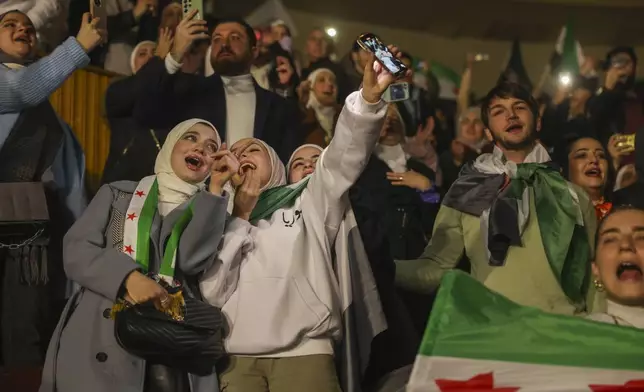FILE.- Syrians sing and wave post-Assad flags during a concert by the recently returned "revolutionary" singer Wasfi Maasrani in Damascus Wednesday Jan. 8, 2025..(AP Photo/Ghaith Alsayed,File)