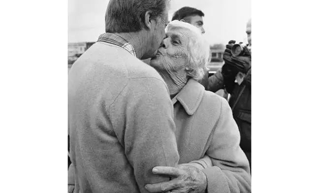 FILE - President-elect Jimmy Carter gets a kiss from his mother, Lillian Carter, on Dec. 6, 1976, in Plains, Ga. (AP Photo/File)