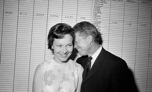 FILE - Georgia State Sen. Jimmy Carter hugs his wife, Rosalynn, at his Atlanta campaign headquarters on Sept. 15, 1966. (AP Photo, File)