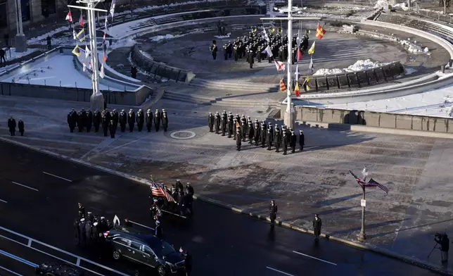 The flag-draped casket of former President Jimmy Carter is transferred to a horse-drawn caisson at the U.S. Navy Memorial before traveling on to the Capitol in Washington, Tuesday, Jan. 7, 2025, where Carter will lie in state. Carter died Dec. 29 at the age of 100. (AP Photo/Mark Schiefelbein, Pool)