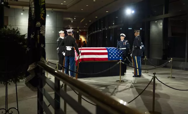 The joint services military honor guard stand around the casket of former President Jimmy Carter as he lies in repose at the Jimmy Carter Presidential Library and Museum in Atlanta, Tuesday, Jan. 7, 2025. Carter died Dec. 29 at the age of 100. (AP Photo/Alex Brandon, Pool)