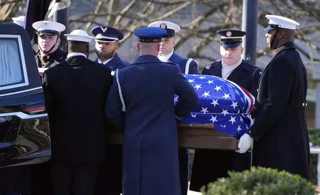 The casket of former President Jimmy Carter is placed into the hearse by a joint services body bearer team from the Jimmy Carter Presidential Library and Museum in Atlanta, Tuesday, Jan. 7, 2025. Carter died Dec. 29 at the age of 100. (AP Photo/Alex Brandon, Pool)