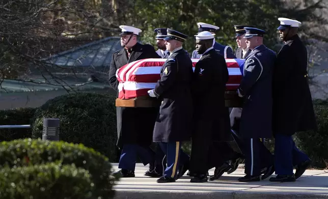 The casket of former President Jimmy Carter is carried by a joint services body bearer team from the Jimmy Carter Presidential Library and Museum in Atlanta, Tuesday, Jan. 7, 2025. Carter died Dec. 29 at the age of 100. (AP Photo/Alex Brandon, Pool)